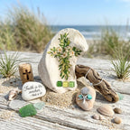 “Hand‑decorated small off‑white shell featuring a green cross accented with cheerful daisies.