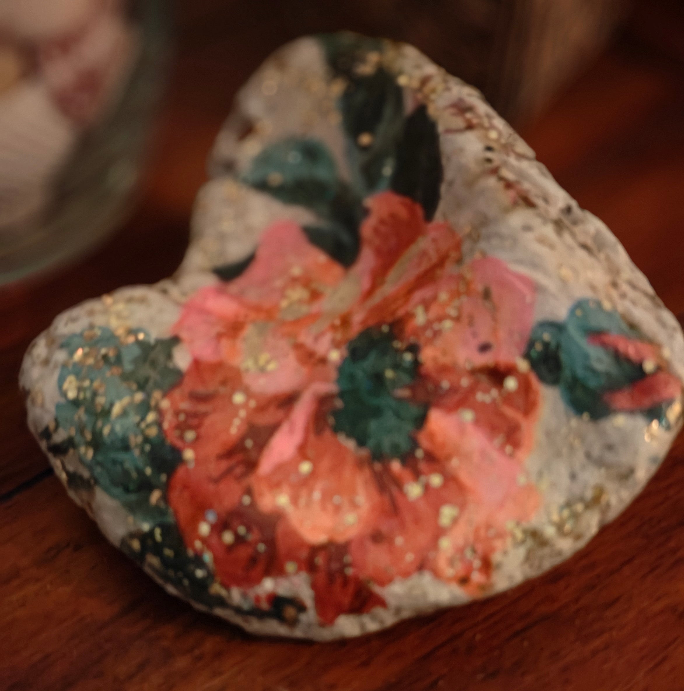 “Hand‑decorated off‑white natural shell featuring a beautiful pink flower design.