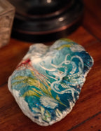 “Hand‑decorated natural shell featuring a whimsical octopus ocean‑scene design.