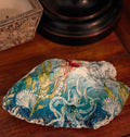 “Hand‑decorated natural shell featuring a whimsical octopus ocean‑scene design.